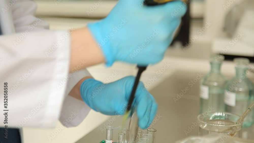 Close up. Lab technician looking through a microscope,close-up shot. HD. Test covid 19 Close up. Lab technician looking through a microscope,close-up shot. HD. Test covid 19