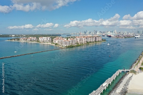 Aerial view of Fisher Island, South Pointe and Government Cut with City of Miami skyline and Port Miami in background. © Francisco