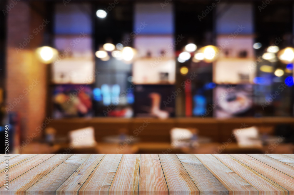 wooden table with abstract blurred background resturant lights used for display montage products mock up design.