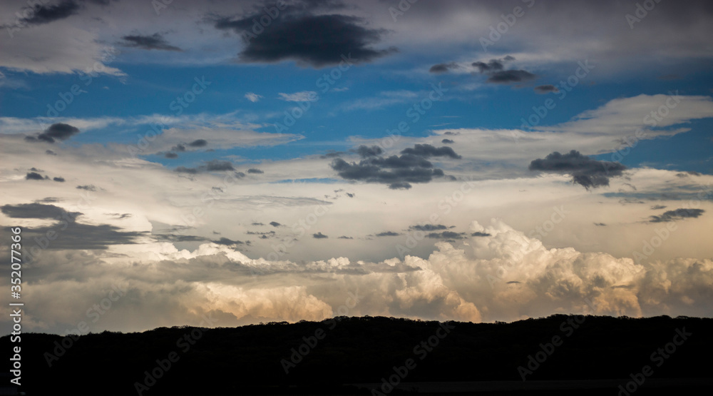 Cumulonimbus Clouds of a Massive Supercell Thunderstorm near Sunset in May Cumulonimbus Clouds of a Massive Supercell Thunderstorm near Sunset in May