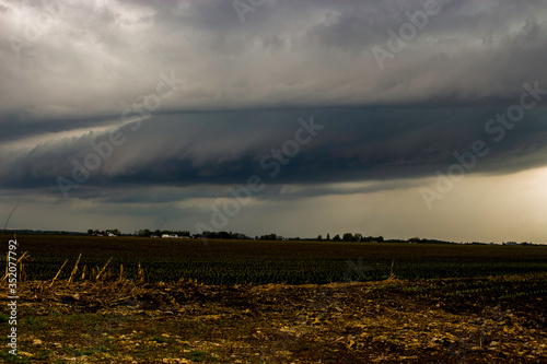 Mothership Supercell Thunderstorm with Rotation and a Funnel Cloud Developing into a Tornado in Janesville, Wisconsin photo