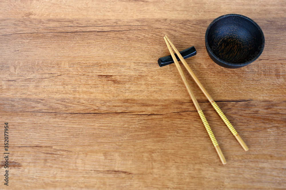 wood chopsticks and bowl on wood table background wood chopsticks and bowl on wood table background