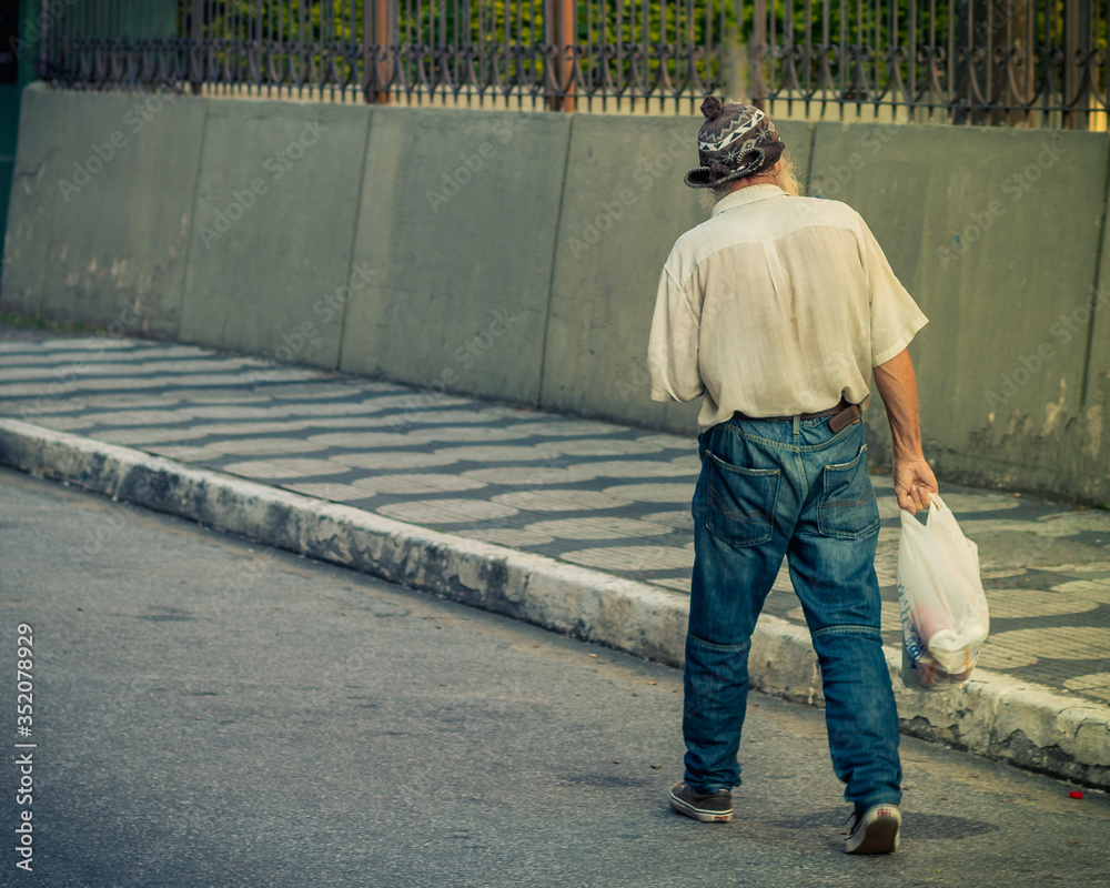 Old man walking on the street Old man walking on the street
