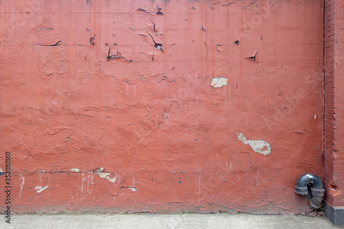 Fototapeta Naklejka Na Ścianę i Meble -  distant image of weathered and distresed painted concrete wall with chips of paint and cracks