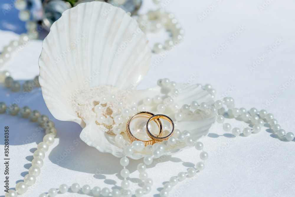Wedding rings close up decorated nautical with accessories for tropical caribbean outdoor wedding ceremony on the sandy beach in Dominican republic, Punta Cana