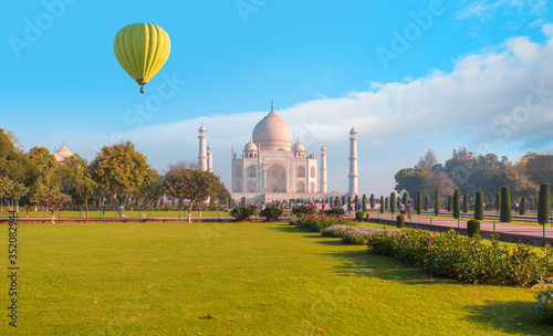Hot air balloon flying over spectacular Taj Mahal at sunset - Agra, India