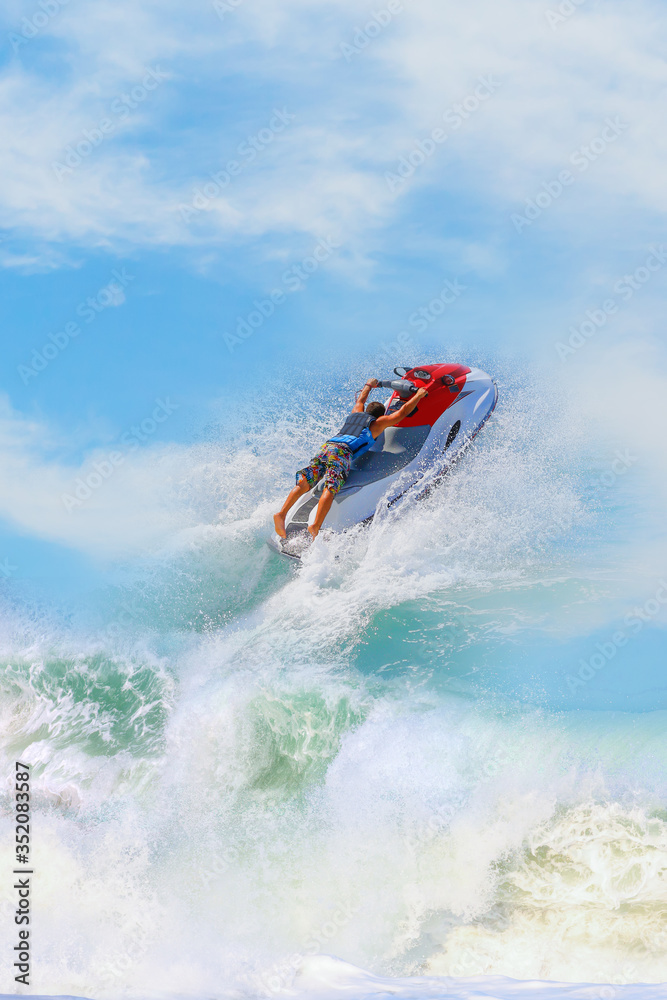 Jet ski driver in action during show with splashing water Jet ski driver in action during show with splashing water