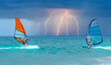 Beautiful cloudy sky with Windsurfer Surfing The Wind On Waves with strom and lightning - In Alacati, Cesme, Turkey 