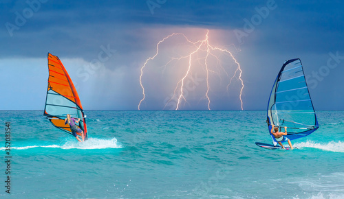 Beautiful cloudy sky with Windsurfer Surfing The Wind On Waves with strom and lightning - In Alacati, Cesme, Turkey 
