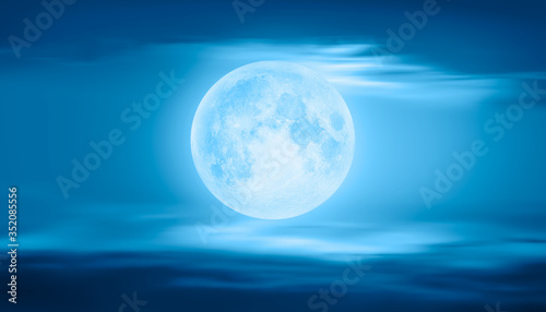 Full moon rising over empty ocean at night with power wave "Elements of this image furnished by NASA"