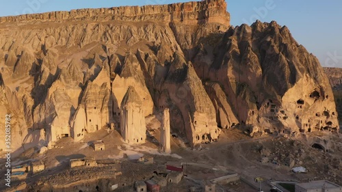 Volcanic rock landscape at Cappadocia, Turkey. Top view of cave town in volcnic rock formation. Stone houses in Goreme. photo