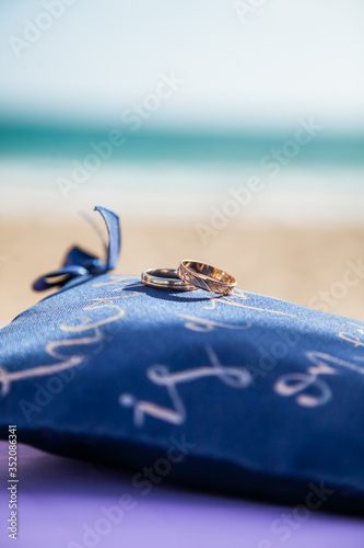 Wedding rings close up decorated nautical with accessories for tropical caribbean outdoor wedding ceremony on the sandy beach in Dominican republic, Punta Cana