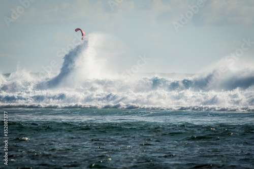 Kiter rides big waves on the island of Mauritius, Indian Ocean