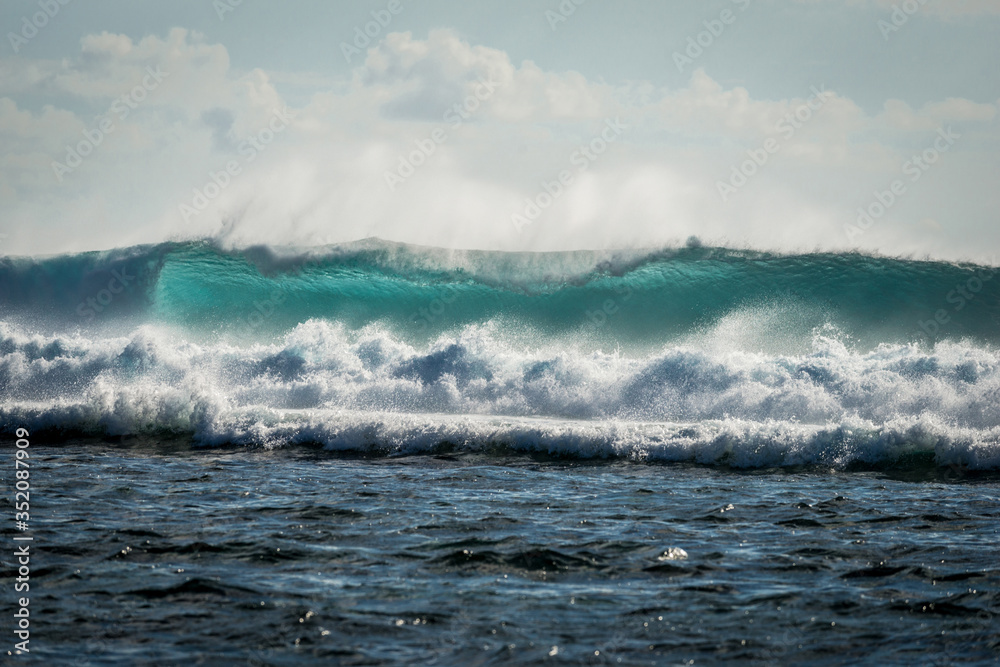 A huge wave for surfing . The photo was taken from the water in the Indian Ocean island of Mauritius