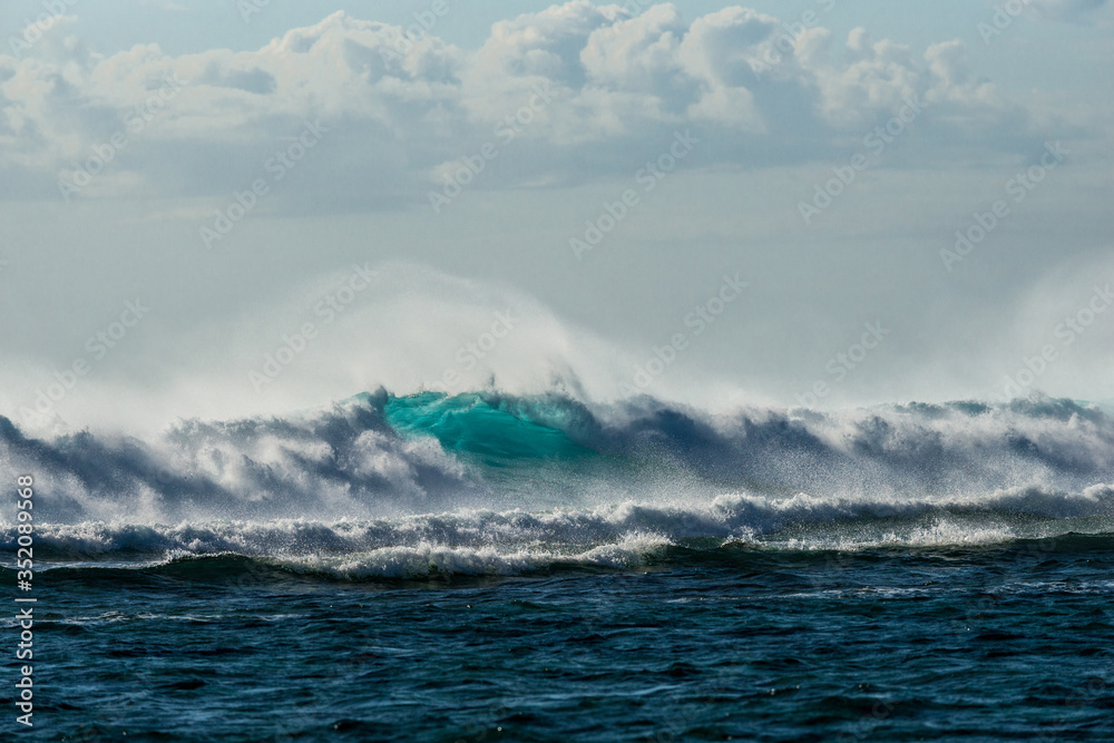 A huge wave for surfing . The photo was taken from the water in the Indian Ocean island of Mauritius