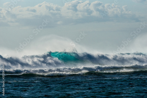 A huge wave for surfing . The photo was taken from the water in the Indian Ocean island of Mauritius © ohrim