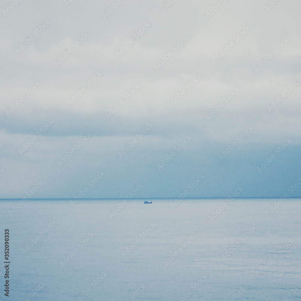 Minimal seascape. abstract of boat sailing in the sea under storm clouds on the horizon with noise and grainy style for Small boats should leave the shore and startup concept.