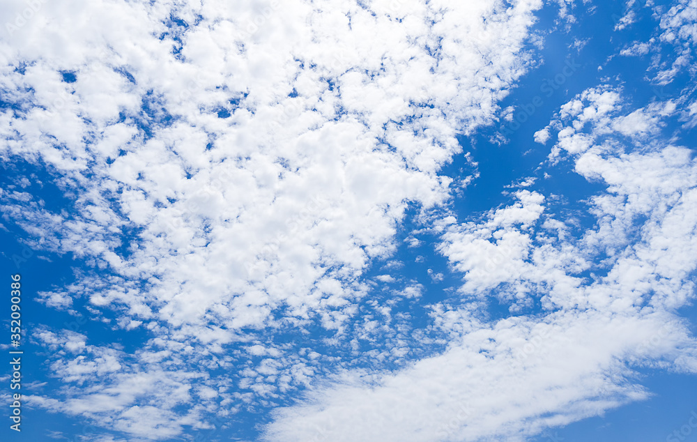Nature background of blue sky full of White fluffy clouds in daytime