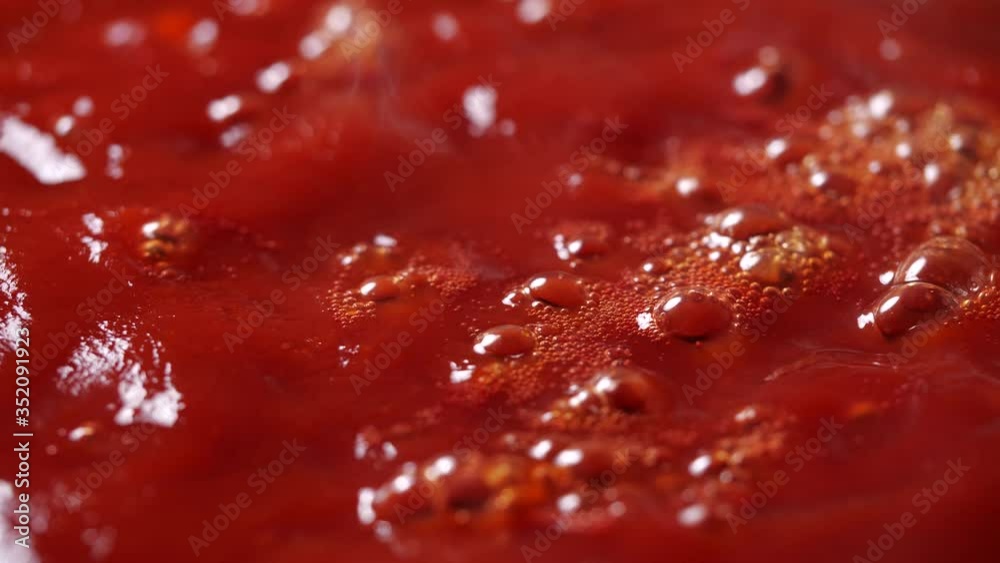 Close-up of boiling red tomato sauce in a pan with steam in 4K Resolution Close-up of boiling red tomato sauce in a pan with steam in 4K Resolution