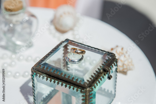 Fototapeta Naklejka Na Ścianę i Meble -  Wedding rings close up decorated nautical with accessories for tropical caribbean outdoor wedding ceremony on the sandy beach in Dominican republic, Punta Cana