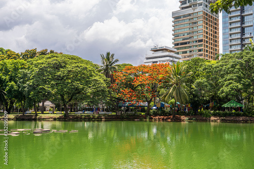 Bautiful view of lake and modern buildings in Lumpini Park, Bangkok, Thailand