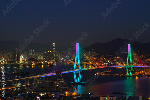 a bridge shining with green and blue lights.Bridge of Busan