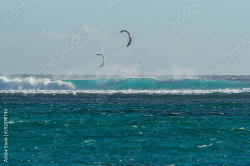 Colorful kites against a background of huge waves of the Indian Ocean. Mauritius Island