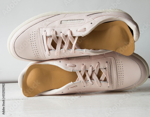 Pink running shoes with orthopedic insoles. White background. photo