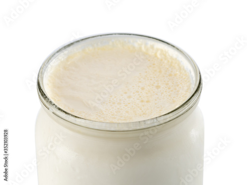 Georgian matsoni yoghurt in a glass pot isolated on white background photo