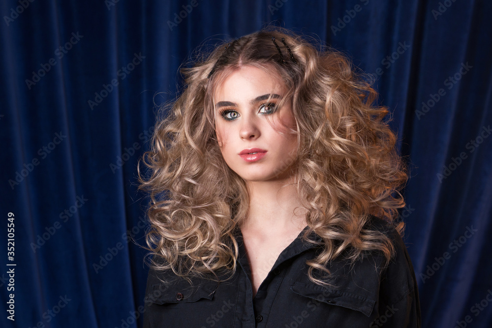 Blonde girl with long and volume shiny wavy hair. Beautiful model woman ...