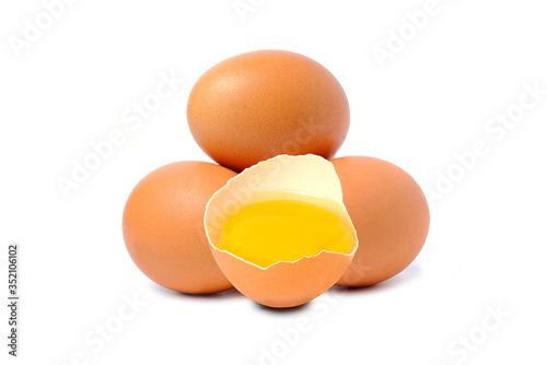 Chicken egg and half with yolk isolated on a white background.