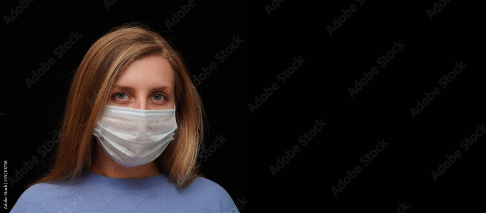 Young woman putting on a medical disposable mask to avoid contagious viruses. Coronavirus outbreak concept. Stay home, stay safe. Copy space for your text. Young woman putting on a medical disposable mask to avoid contagious viruses. Coronavirus outbreak concept. Stay home, stay safe. Copy space for your text.