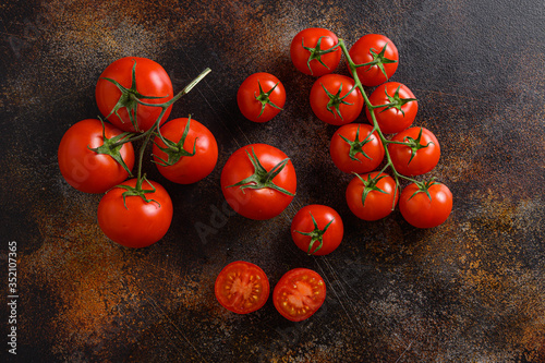 Fresh cherry tomatoes on a metal rustic old background  space for text.