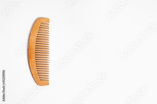 Wooden comb for hair Isolated on white background.Hairbrush.High-resolution photo.Top view.
