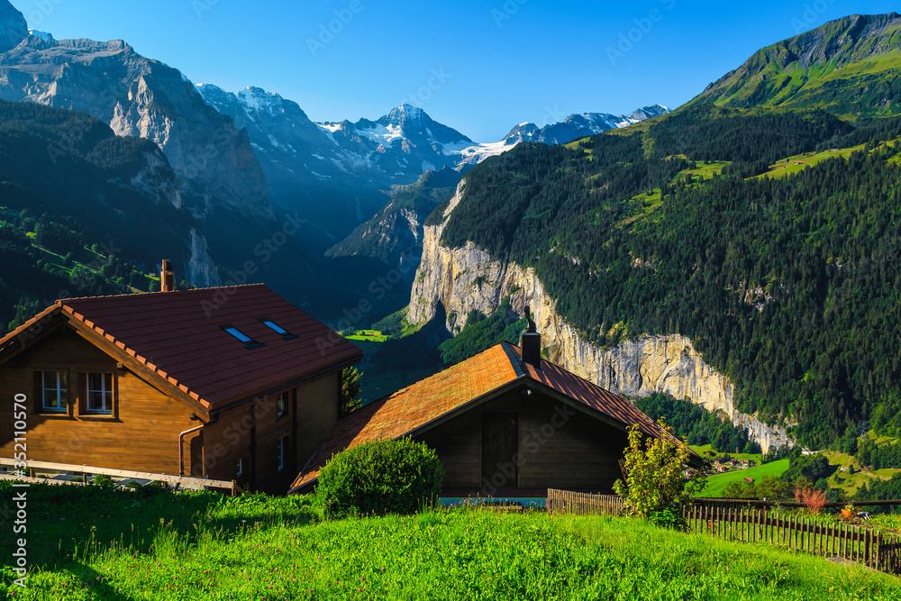 Wooden houses on the hill with great views, Wengen, Switzerland Wooden houses on the hill with great views, Wengen, Switzerland