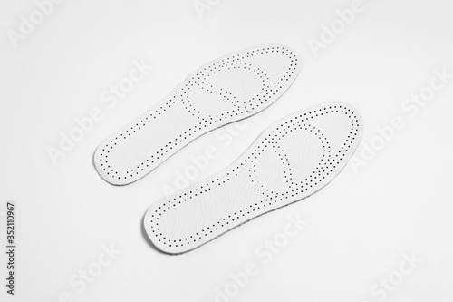 Leather insoles for shoes isolated on white background.High-resolution photo.Perspective view.
