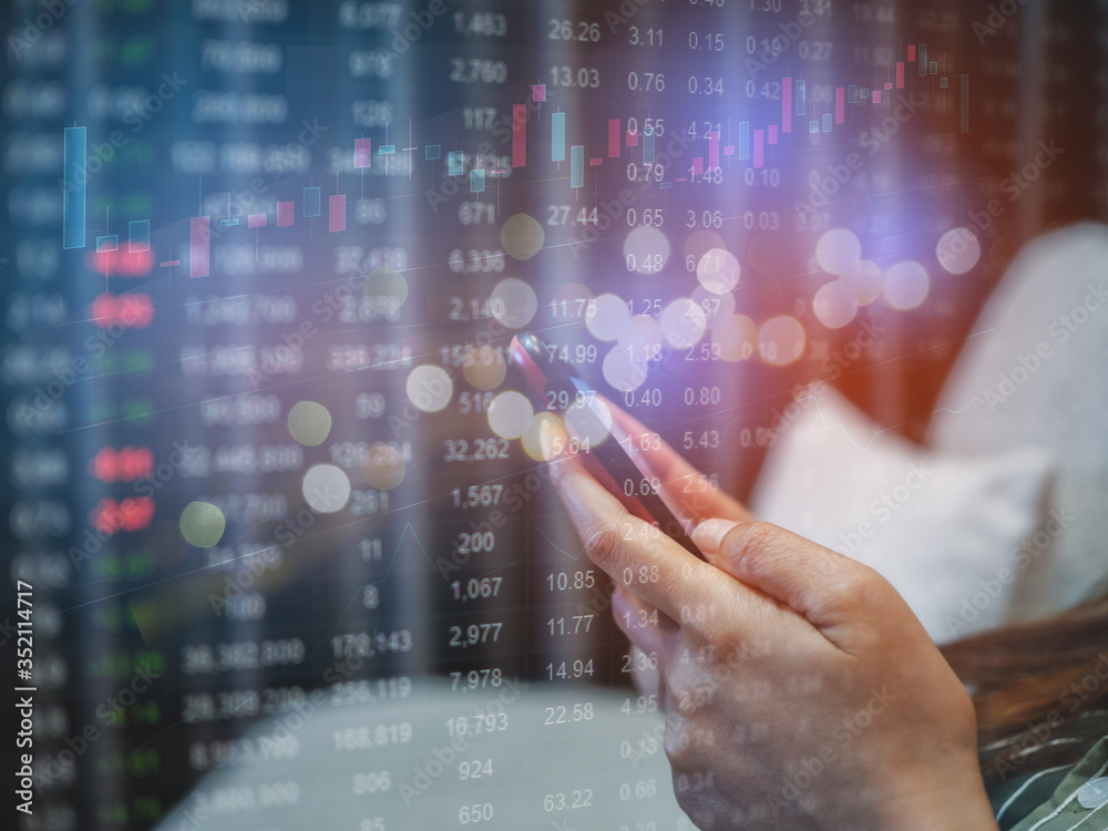 People sue smartphone on desk with with business graph, in concept of business online and finance or stock. People sue smartphone on desk with with business graph, in concept of business online and finance or stock.