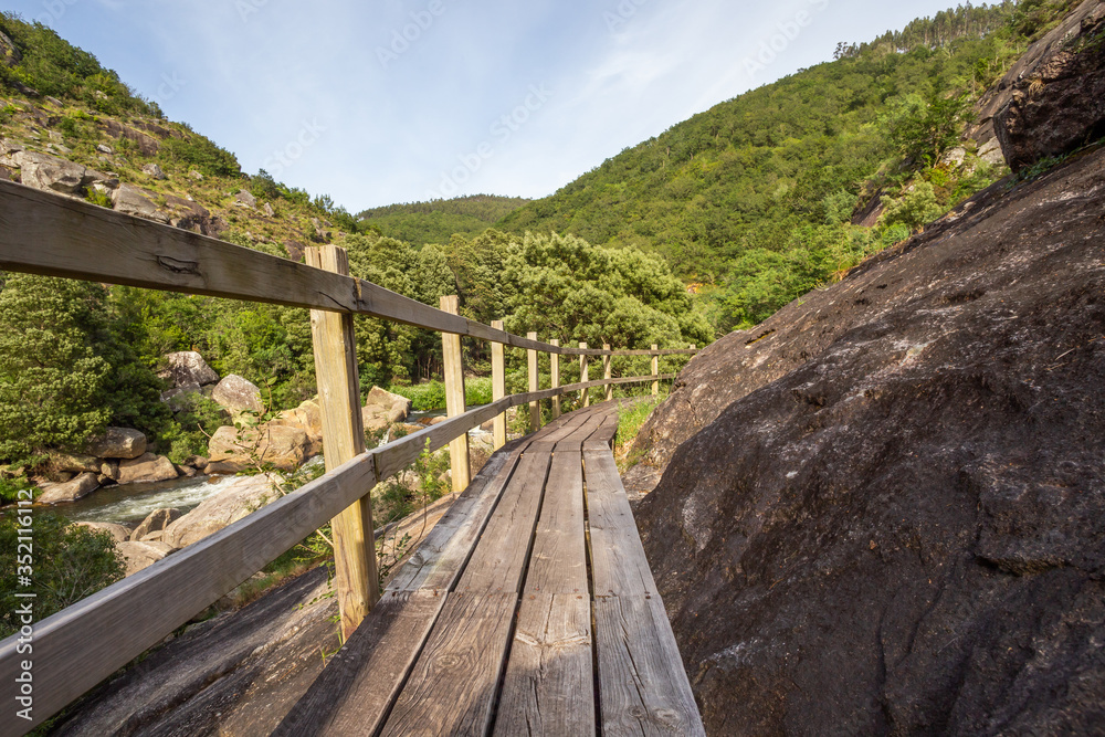 Wooden path down a gorge beside a river