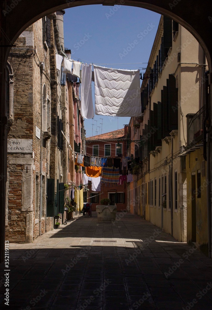 Ancient road in Venice with cloths hang out to dry