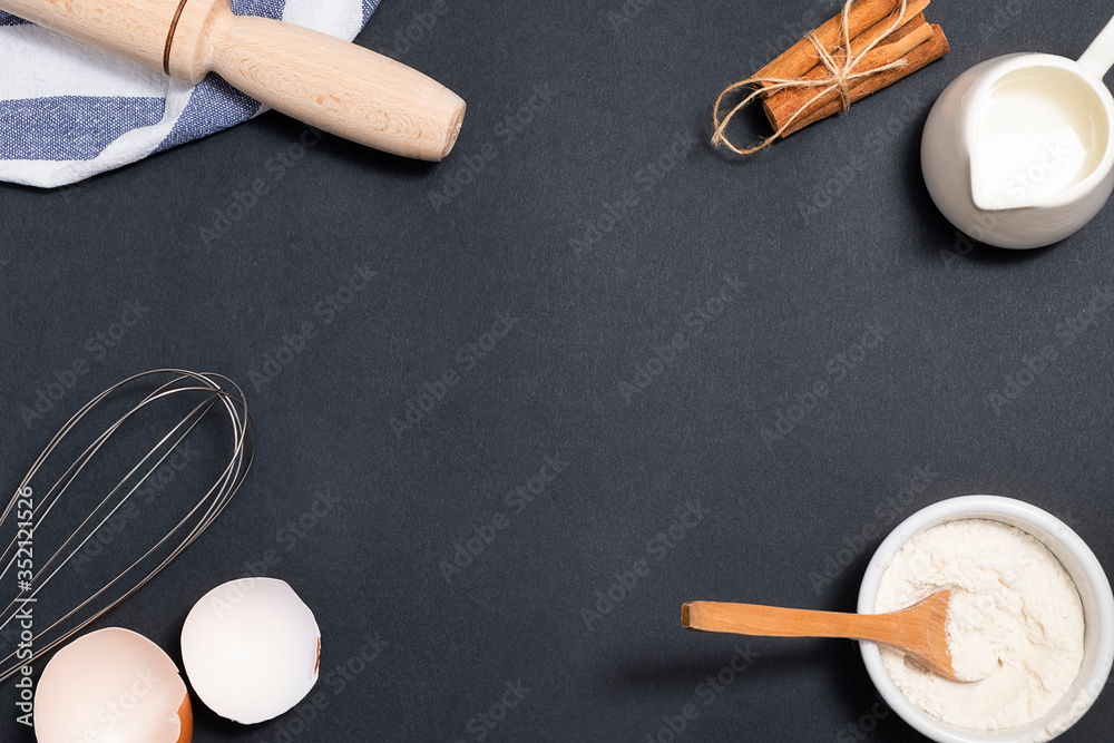 Baking background. Cooking ingredients for dough and pastry on black background Baking background. Cooking ingredients for dough and pastry on black background