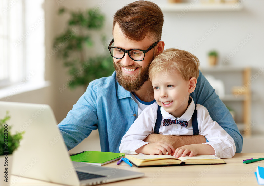 Father helping child with online lesson at home. Father helping child with online lesson at home.