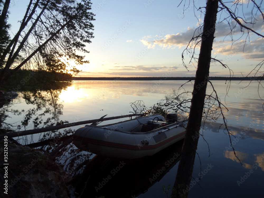 Obraz premium Sunset over taiga lake.