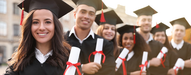 Happy students with diplomas near campus. Banner design
