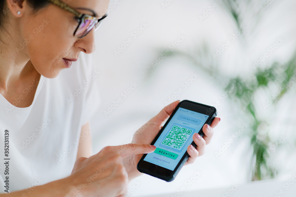 Corona Virus App. Woman Holding Smartphone with Application for Checking Health Status for COVID19. Corona Virus App. Woman Holding Smartphone with Application for Checking Health Status for COVID19.