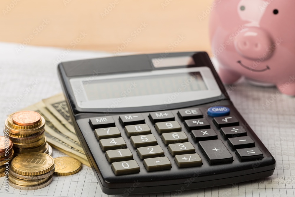 Coin money and banknote bills with a calculator. ballance reduction Coin money and banknote bills with a calculator. ballance reduction