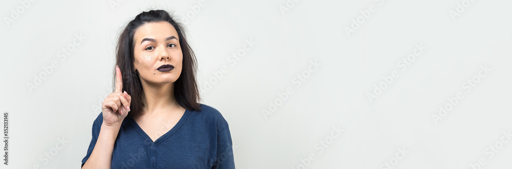 Image of excited young lady with glasses. Looking camera have an idea. Stands on a white background. Image of excited young lady with glasses. Looking camera have an idea. Stands on a white background.
