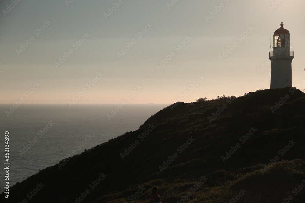 Sea horizon with light house on top of the hill