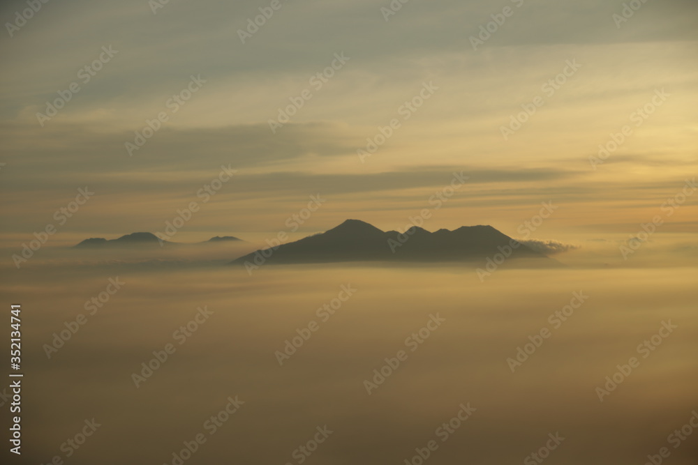 Mountain top over the clouds on sunrise