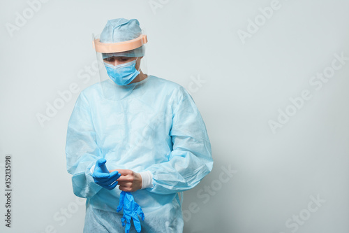 Doctor wearing surgical face mask and gloves.