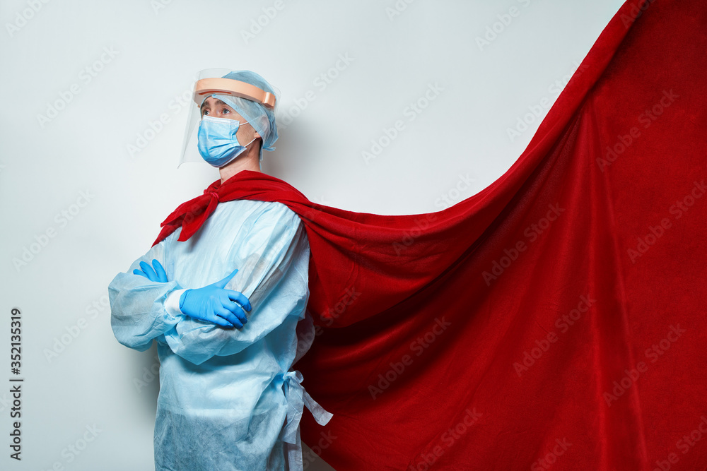 Doctor wearing surgical face mask in superhero cape.